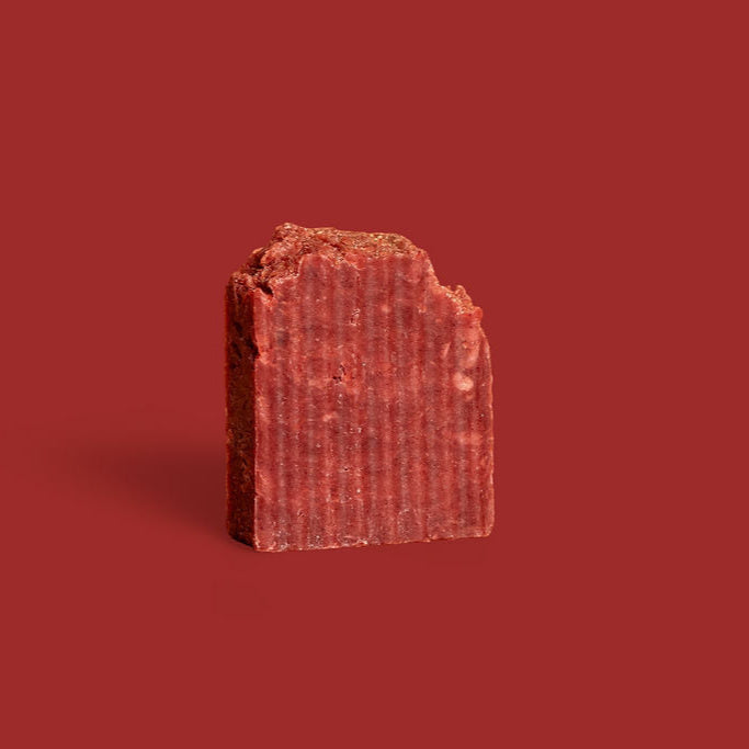 red rectangular bar of soap on a red background